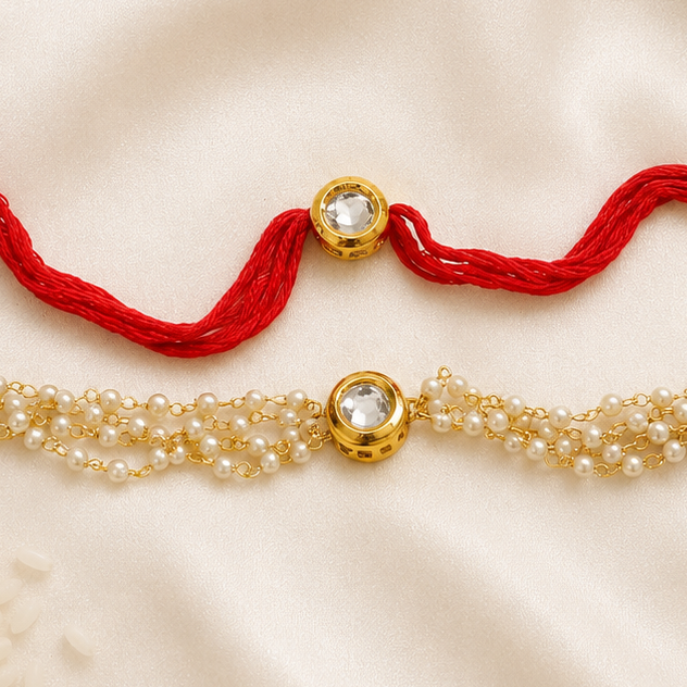 Bhai-Bhabhi Rakhi Set with a gold-tone Kundan rakhi on a red thread and a matching pearl bracelet for Bhabhi, displayed on a silk background.